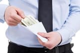 bribe-cropped-image-of-man-in-shirt-and-tie-taking-money-from-the-envelope-while-standing-isolated-on-white-photo