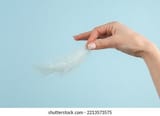 womans-hand-hold-soft-feather-26