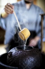 man_using_a_Hishaku_a_bamboo_ladle
