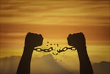 silhouette-hands-and-broken-chains-freedom-concept-photo