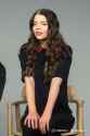401026853830770690_A_woman_sitting_on_a_chair_hap_thumb.jpg
