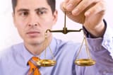 6601541-a-business-man-holding-a-justice-scale-isolated-in-white-background