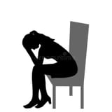 sad-woman-sitting-chair-holding-her-head-her-hands-sad-woman-sitting-chair-holding-her-head-her-hands-223242533
