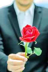 a-man-is-giving-red-rose-is-focused-at-the-rose-free-photo