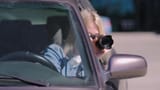 depositphotos_648904140-stock-video-woman-camera-sits-car-takes