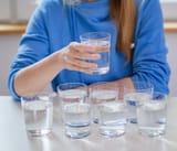 a_woman_with_glasses_of_water