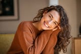 young-woman-laughing-while-relaxing-at-home[1]