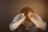 sad-man-holding-head-with-hand_1150-6345