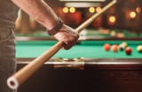 man-holding-billiard-cue