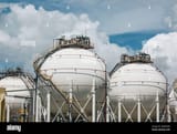 white-spherical-propane-tanks-containing-fuel-gas-in-the-blue-sky-2JFMKMG