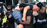 s7mu91k8_black-man-carries-protester-to-safetylondon650_625x300_15_June_20