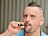 depositphotos_77079263-stock-photo-down-syndrome-man-with-electronic