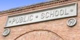 public-school-sign-brick-building-5310531