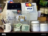 money-in-tip-jar-beside-cash-register-BF8E2G