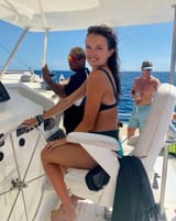 Me driving a catamaran featuring my scorched calves --)