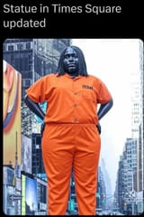 fat black woman statue in times square in prison garb clothes