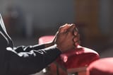 close-up-african-man-praying-front-altar-church_236854-30948