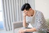 152703536-sideview-of-asian-man-feel-depressed-and-sitting-at-home