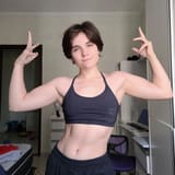 short haired tomboy flexes