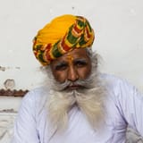 14581258-an-old-indian-man-with-a-beautiful-beard-and-yellow-turban-rajasthan-india