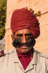 14581261-an-indian-man-in-uniform-with-a-beautiful-mustache-and-red-turbans-in-rajasthan-india