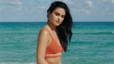 beautiful_actress_camila_mendes_is_standing_in_ocean_waves_background_wearing_red_dress_hd_girls-2560x1440