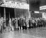 Unemployed_men_queued_outside_a_depression_soup_kitchen_opened_in_Chicago_by_Al_Capone,_02-1931_-_NARA_-_541927