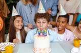 boy-blowing-out-his-birthday-candles