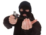 burglar-wearing-mask-holding-gun-aiming-towards-camera-34956077