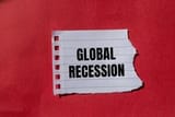 global-recession-message-written-on-ripped-torn-paper-with-red-background-conceptual-global-recession-symbol-copy-space-photo