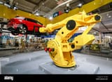 hanover-lower-saxony-germany-hanover-fair-industrial-robot-on-the-fanuc-booth-lifts-a-car-here-on-the-press-highlight-tour-the-day-before-the-fa-T2PTB8