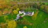evening-aerial-view-of-scenic-rural-home-in-springtime-picture-id534320326