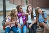 group-of-teenage-girls-laughing-and-talking-together-at-school[1]