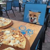 fox-near-some-pizza-v0-xiuh6fr7ki2e1