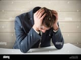 composite-image-of-businessman-with-head-in-hands-EJ45J6