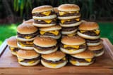 a-pile-of-hamburgers-stacked-on-top-of-each-other-photo