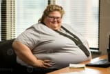 a-fat-woman-sitting-at-a-desk-generative-ai-photo