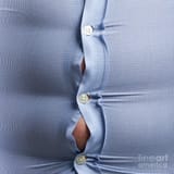 4-overweight-man-with-bulging-shirt-buttons-science-photo-library