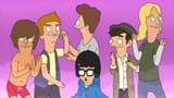 Tina kneeling in front of a group of boys