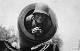 A German soldier poses in the barrel of a long range Paris Gun, during the 1918 Spring Offensi..