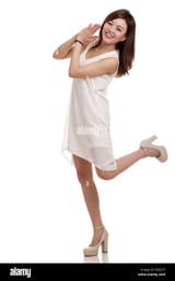 asian-woman-looking-happy-kicking-one-leg-behind-her-E0D275