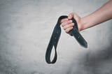 hand-holds-leather-belt-punishment-600nw-1182492379[1]