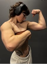lean beef patty tom boy massive arms flexing abs fit with headphones