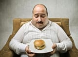 sad-fat-man-looking-hamburger-260nw-79925632