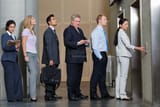 lovepik-businessmen-waiting-in-line-for-an-elevator-picture_501510343