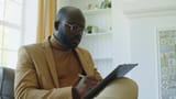 black-psychologist-taking-notes-at-workplace-3668675-high_0011[1]