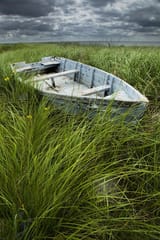 old-weathered-row-boat-abandoned-in-the-grass-on-pei-randall-nyhof