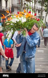 man-carrying-flowers-on-shoulder-DD9GM9