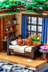 FLUX-00394-Lego world, Lego Australian brown color scheme round cheeks long tail small adorable lego quokka sleeping on comfy lego bed closed eyes laying down, large Lego sunny plain house interior, isometric.PNG