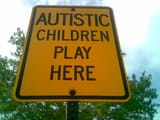 road sign autistic children yellow